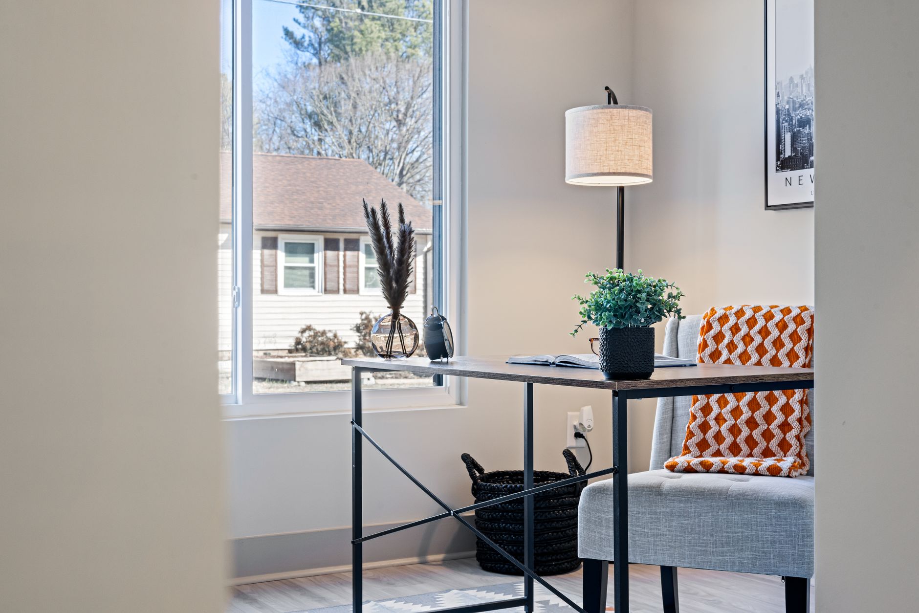 A bright minimal desk beside a window with morning light across it